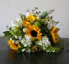 We love creating stunning wedding flowers and we like our designs to be perfect for the person they are for. Bridal Bouquet Of Sunflowers Bells Of Ireland Stock Seeded Euculyptus And September Yellow Wedding Flowers Flower Centerpieces Wedding Blue Wedding Flowers