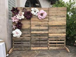 How To Make Rustic Wedding Decorations On A Budget Backdrops Pallet Wall With Paper Flowe Rustic Wedding Diy Backyard Bridal Showers Rustic Wedding Backdrops