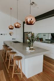 All white kitchen with white moldings and cabinetry, wood top island, wide plank wood flooring, brass hardware. Find Other Ideas Kitchen Countertops Remodeling On A Budget Small Kitchen Remodelin Farmhouse Kitchen Remodel Interior Design Kitchen White Kitchen Remodeling