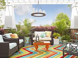The casual beachy feel is conveyed through the board and batten wall, douglas fir ceiling beams, brick flooring and wicker furniture with blue and white striped cushions. Back Porch Decorating Ideas Hgtv