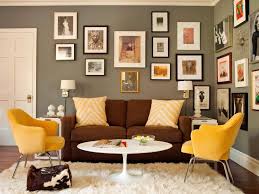 Cindy crawford living room set gray sofa set with brass nailhead details, dark brown wood legs, a rich brown coffee table and a beige rug. Gray Green Home Office Sitting Area With Gallery Wall Brown Couch Living Room Brown Living Room Living Room Grey