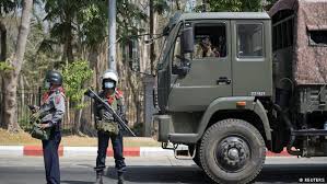 Photos of men in green military uniforms sitting in seats of power. Myanmar Military Supporters Attack Anti Coup Protesters News Dw 25 02 2021