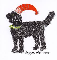 Cute pug puppy wearing red scarf and antlers sitting on toboggan with gifts, winter snowy hills with trees in background. Christmas Dog Cockapoo