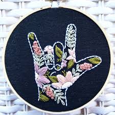 This sign is similar to the gesture of kissing one's hand and extending the hand towards someone else. Asl I Love You Embroidered Hoop With Antiqued Flowers Embroidery Wall Art I Love You Signs Sign Language Tattoo
