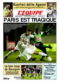 Pictogramme représentant une loupe, illsutrant la notion de recherche sur le site. Une De L Equipe Datee Du 03 Decembre 2000