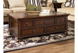 You can choose from a selection of different colors. Ashley Signature Design Porter Storage Cocktail Table With 5 Drawers Johnny Janosik Cocktail Coffee Tables