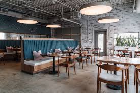 Atlanta S Lazy Betty Restaurant Pairs Industrial Details And Pops Of Teal Restaurant Seating Restaurant Interior Design Stools For Kitchen Island