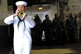 Engineman 2nd Class Marc Scavone performs taps during