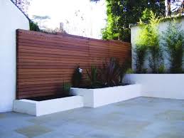 Wood fencing adds a bit of rustic charm to your yard, and you can probably find plenty of usable material in the woods near your home. Fence And Planters Back Corner Of Yard Modern Fence Design Backyard Fences Fence Design
