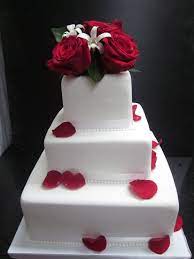 Simple Fondant Cake With White Ribbon And Scattered Red Rose Petals Three Tiered Wedding Fondant Wedding Cakes Simple Wedding Cake Wedding Cakes With Flowers