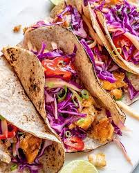Assemble tacos on a tortilla with fish, pickled onions, guacamole, and fish sauce. Cleanfoodcrush Fish Tacos With Limey Mango Cabbage Slaw Facebook