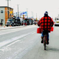 With the Tampa skyline in the background, US Air Force MASTER Sergeant Alex  Aceves and his wife, Starr, take a weekend stroll along MacDill's Bayshore  Boulevard with their children, Alex, 14 and