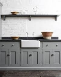 Light blue gray kitchen cabinets with quartz countertop. The Many Advantages Of Black Kitchen Countertops Decorated Life