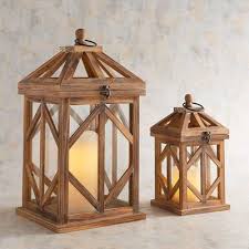 Embellished By An Intriguing Design Our Exclusive Wooden Lanterns Let You Light Up The Night In Style Wood Lantern Lantern Decor Living Wooden Lanterns