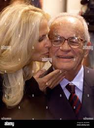 FILE -- In this Sept. 5 2000 file photo, Italian producer Dino de  Laurentiis receives a kiss from his wife Martha at the American Film  Festival in Deauville, France. De Laurentiis,