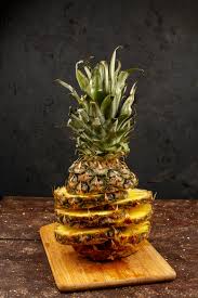 The pineapple is a member of the bromeliad family. Pineapple Slices Mellow Ripe Juicy Beautifully Designed On Brown Desk And Wooden Floor Free Photo Nohat Free For Designer