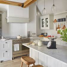 Quality and true craftsmanship can be seen in the details of our shaker style kitchens. Classic Kitchen Makeover With Pale Grey Shaker Cabinets And Carrara Marble Worktops