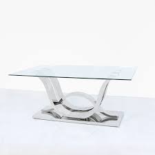 Table top is in a rectangular shape and includes one bottom shelf. Corsica Clear Glass Coffee Table Modish Furnishing
