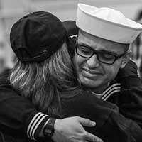 Boatswain s Mate 1st Class Larry Sherrill, aboard guided-missile frigate  USS Vandegrift (FFG 48), watches a demonstration of the bowline knot from  Leo Oates, a journeyman lineman for Clark Public Utilities.