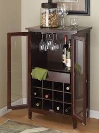 Tall liquor cabinet constructed from wood and finished with a mystic black pallet. Gettington Alcove Wine And Liquor Cabinet Dark Walnut