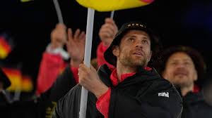 Leon Draisaitl carries flag for Germany at opening ceremony before Olympic debut