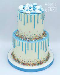 Birthday comes once in a year and there would be nothing more sweet then making it the most memorable day for the birthday boy. 2 Tier Blue Drip Cake Decorated With Colourful Sprinkles Tiered Cakes Birthday Blue Drip Cake Rainbow Birthday Cake