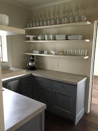 Rustic kitchen design with gray cabinets and concrete countertops. A Gracious Houston Home Grey Kitchen Cabinets New Kitchen Cabinets Kitchen Remodel Countertops
