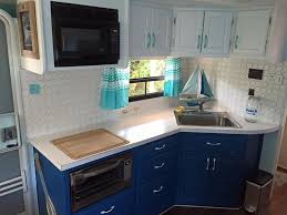 Our Beach Themed Rv Remodel New Kitchen That Has Had The Cabinets Repainted New Counter Top And Tile Back Splas Rv Kitchen Remodel Kitchen Remodel Rv Remodel