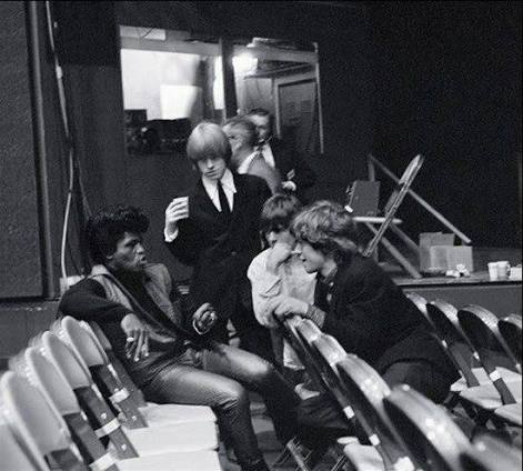 James Brown and members of the Rolling Stones at the T.A.M.I. Show in 1964. Photo by Bob Bonis. After seeing Brown's set, the Stones were reportedly terrified to follow him on stage.