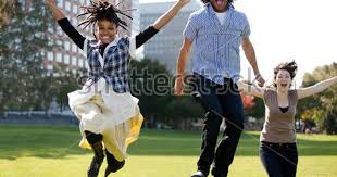 A Group Of People Jumping For Joy In A City Park Jumping For Joy Park City Photo