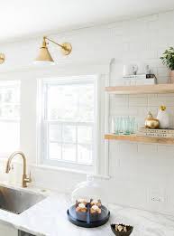 White And Gold Kitchen Features White Shaker Cabinets Adorned With Brass Pulls Paired With Calcutt Kitchen Inspirations Kitchen Renovation Contemporary Kitchen