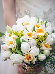 15 Fresh Takes On Tulip Bouquets Theknot Com Daffodil Wedding Tulip Bouquet Spring Wedding Bouquets
