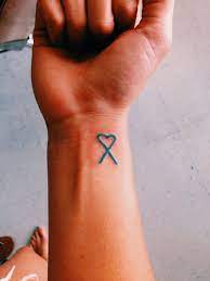 Perhaps the most popular type of cancer tattoo, a simple ribbon says all that needs to be said. Pin By Walk Of Hope Saskatoon On Teal Awareness Tattoo S Cancer Awareness Tattoo Cancer Tattoos Cancer Ribbon Tattoos
