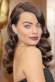 Posted this selfie on her instagram story revealing her new red hair color. Margot Robbie Wavy Dark Brown Pin Curls Side Part Hairstyle Steal Her Style