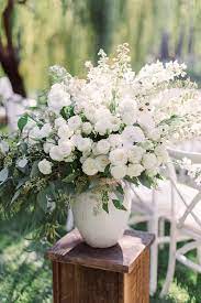 Blooms En Blanc Add Lush Floral Arrangements On Either Side Of Your Wedding Aisle For A White Flower Arrangements Ceremony Flowers Wedding Flower Arrangements
