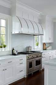 White Barrel Kitchen Vent Hood With Stainless Steel Straps Suggest An Old Vintage Trunk Like Design Over A S Kitchen Vent Kitchen Vent Hood Kitchen Hood Design