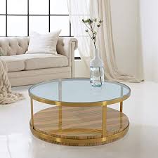 An elegant gold coffee table with a glass top to show off the decor underneath. Armen Living Hattie Glass Top Coffee Table With Brushed Gold Legs Yellow From Armen Living Accuweather Shop