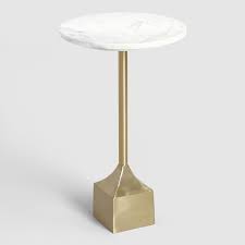 Metal hardware accents and the brushed driftwood finish top are an interesting pair. Marble And Gold Metal Norah Accent Table By World Market World Market Cost Plus Accent Table Family Room Furniture Marble Side Tables