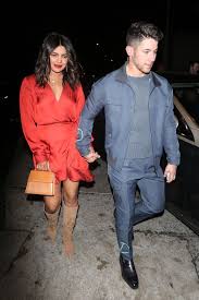 Priyanka Chopra In A Little Red Dress And Tan Suede Boots With Nick Jonas Out And About In Los Angeles On Oct 21 Priyanka Chopra Little Red Dress Fashion