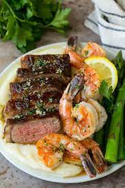 Step 1 whisk 1 tablespoon olive oil, butter, onion, wine, worcestershire sauce, lemon juice, parsley, seafood seasoning, garlic, and black pepper together in a bowl; Surf And Turf Recipe Dinner At The Zoo