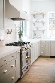 Wood grey kitchen images cabinets on either side of a beamer. Light Gray Cabinets With Gold Hardware Vintage Range Open Shelving Next To Sink Pot Filler L Kitchen Design Light Grey Kitchen Cabinets Light Grey Kitchens