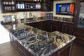 A golden beige background with creamy, black, and brown specks. Magma Gold Bar Granite Kitchen Man Cave Bar Kitchen Remodel