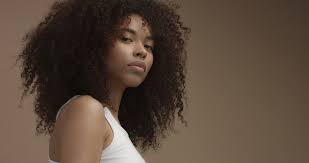 Achieving the big afro styles you love on your natural hair can be quick and easy. Mixed Race Black Woman Portrait With Big Afro Hair Curly Hair In Beige Background Stock Images Page Everypixel