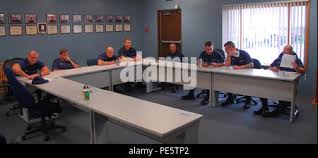 Members of Coast Guard Station Harbor Beach, Mich., stand ready for the  station's morning meeting, Sept. 28, 2015. Pictured in the photo are Petty  Officers 3rd Class Dustin Pitman, Jeffery Neal, Brandon