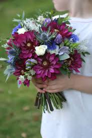 Creamy roses, cafe au lait dahlias, and plenty of foliage will make for a gorgeous autumnal affair. Wedding Bouquet In Burgundy Blue Lilac And White Including Dahlia Thistles November Wedding Flowers Sunflower Wedding Bouquet White Wedding Flowers Bouquet