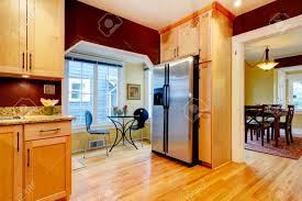 Wood tsca title vi increase the access to the items in your cabinets with this lazy susan tray. Cozy Kitchen With Burgundy Walls And Light Wood Cabinets Open To Bright Dining Area Stock Photo Picture And Royalty Free Image Image 25668290