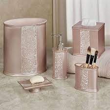 A contemporary pink bathroom clad with pink tiles in a herringbone pattern, gold fixtures and frames for a glam look. 20 Pink Bathroom Accessories Magzhouse