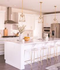 white kitchen with brass pendant lights