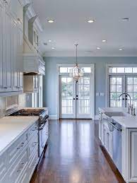 A pastel blue island is the perfect compliment tone for an all white kitchen it bold yet subtle all at the same time. Popular Paint Color And Color Palette Ideas Home Bunch An Interior Design Luxury Homes Blog Popular Kitchen Colors Light Blue Kitchens Blue Kitchen Walls