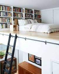 The Small Bedroom Of A Split Level Studio With Built In Book Shelves And Tiny House Storage Home European Home Decor
